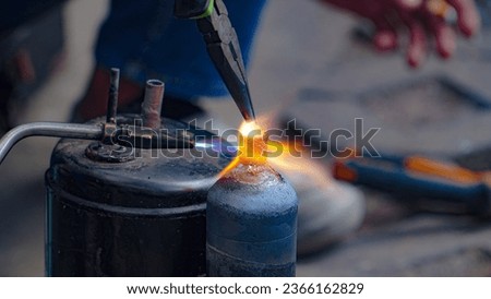 Industry system men worker welds joint of copper pipe air conditioner and brazing of copper tube in air conditioning installation. Air conditioning condenser brazing coil that is leaking.