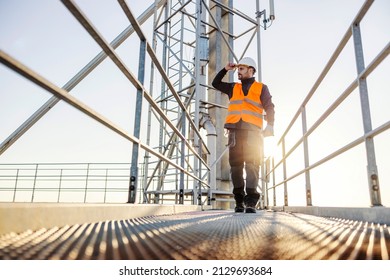 An industry walking on the silo and going to his workplace. - Powered by Shutterstock