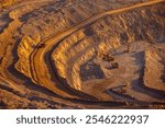 Industry work of trucks and excavator in open pit on gold mining, drilling machine.