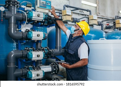 Industry Worker Checking Chemical Water Treatment Equipment