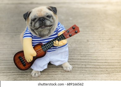 Indy Musician Guitarist pug dog.(Funny pug dog wearing indy musician costume with Ukulele.) - Shutterstock ID 689166562