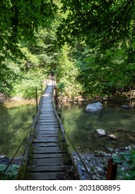 Inelet, Romania - August 11 2021: Bridge over Cerna river on the trail to Ineleț and Scărişoara hamlets. Those are two isolated villages in Cerna Mountains. - Shutterstock ID 2031808895