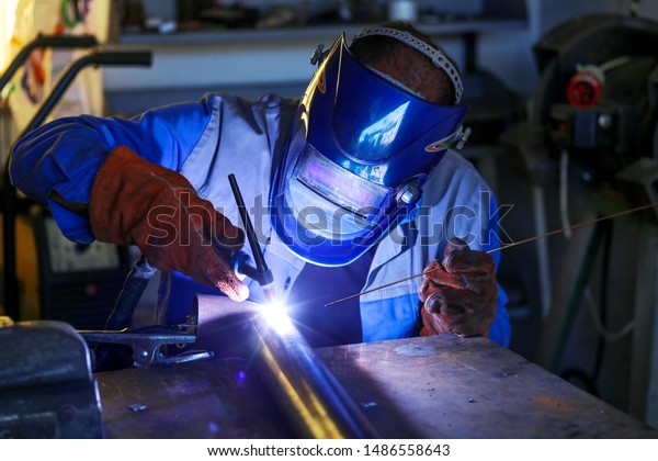 Inert gas welding in a\
workshop