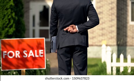 Inexperienced broker crossing fingers behind his back before selling house, luck - Shutterstock ID 1509637823