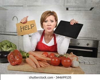 Inexperienced Home Cook Woman In Red Apron Screaming Desperate And Frustrated At Domestic Kitchen In Stress Holding Digital Tablet Asking For Help In Amateur And Rookie Cooking Mess 