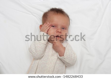 Similar – Image, Stock Photo Baby lies on a blanket and covers his eyes with his hands