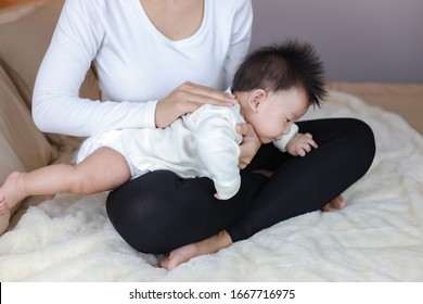 Infant baby boy belching after drink breast milk by mother 
