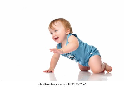 Infant Baby Boy Crawling And Looking Happy At Corner Isolated On White Background. A Boy With Blue Eyes In A Blue Bodysuit Is About To Get On All Fours And Crawl. Banner. Place For Your Text.