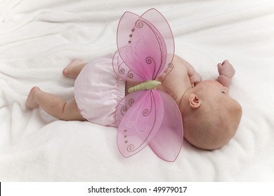 Infant Baby Girl In Clouds With Fantasy Butterfly Wings