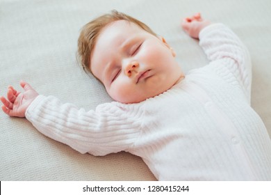 Infant Baby Sleeping On White Sheets  