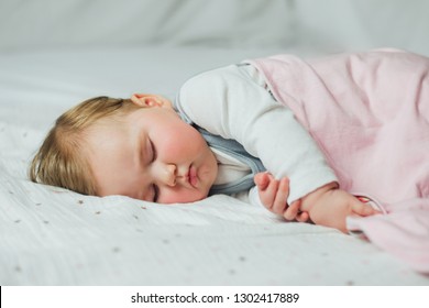 Infant baby sleeping on white sheets  - Shutterstock ID 1302417889
