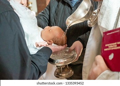 Infant Baptism. Baptism Ceremony In Church. Water Is Poured On The Head Of An Infant.