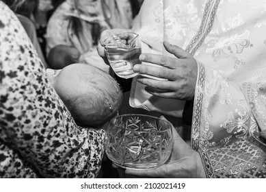 Infant Baptism. Baptism Ceremony In Church. Water Is Poured On The Head Of An Infant.