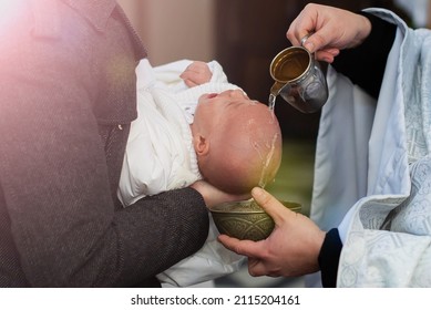 Infant Baptism. Water Is Poured On The Head Of An Infant. Baptism Ceremony In Church.