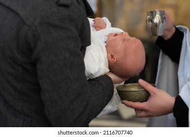 Infant Baptism. Water Is Poured On The Head Of An Infant. Baptism Ceremony In Church.