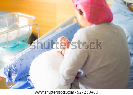 infant is born for 3 days. so mother hold the baby carefully . baby is being carried by mother.mother loves her daughter.