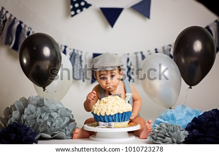 Infant boy's first birthday cake smash Adorable baby smashing cake