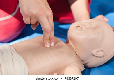 Infant Chest Compressions Practice On A CPR Dummy