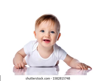 Infant Child Baby Boy Kid With Blue Eyes Happy Smiling Screaming Lying On A Floor Isolated On A White Background. Closeup Portrait