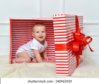 Infant Child Baby Toddler Kid Sitting In Presents Gift For Celebration. Christmas New Year Concept. 