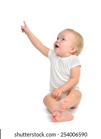 Infant Child Baby Toddler Sitting Raise Hand Up Pointing Finger At The Corner Isolated On A White Background