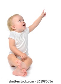 Infant Child Baby Toddler Sitting Raise Hand Up Pointing Finger At The Corner Isolated On A White Background