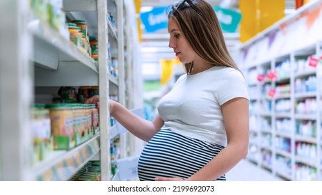 Infant Formula Woman Shopping. Young Pregnant Woman Buying Infant Baby Formula Milk On Supermarket Background. Healthy Baby Formula Concept