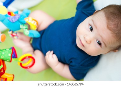 Infant playing in his crib