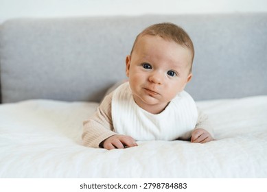 Infant practicing tummy time while lifting and holding the head independently. Early childhood developmental milestone that helps strengthen neck, shoulder, and upper body muscles.