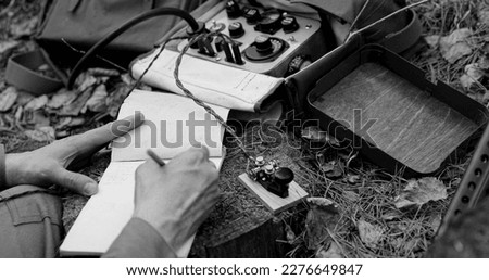 Infantry Army Soldier In World War II using Portable Radio Transceiver In Trench Entrenchment In Forest. . Headphones And Telegraph Key. Close Up Hands, Black And White Colors.