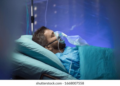 Infected Patient In Quarantine Lying In Bed In Hospital, Coronavirus Concept.