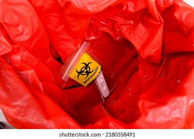 Infectious Biohazard Specimen Bag Of Covid-19 Test In The Red Infectious Waste Bin