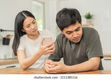 Infidelity, Suspicion Asian Young Couple Love Fight Relationship, Wife Holding Cellphone, Smartphone Cheating On Phone, Scolding Husband About Mistrust, Distrust And Jealousy When Sitting At Home.