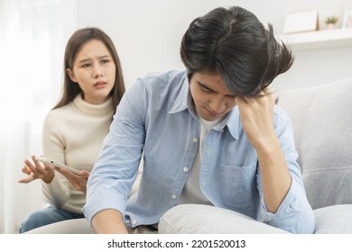 Infidelity, Suspicion Asian Young Couple Love Fight Relationship, Wife Holding Cellphone, Smartphone Cheating On Phone, Scolding Husband About Mistrust, Distrust And Jealousy When Sitting At Home.