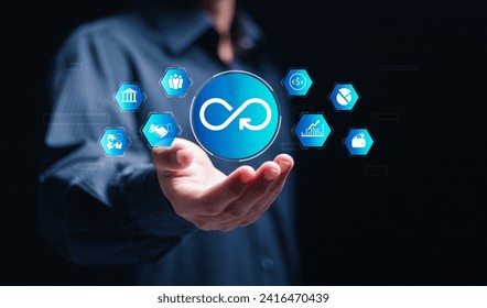 Infinite possibilities in business, Businessman holds virtual Infinity symbol, Circular Economy and endless potential. Strategic investment, banking, and financial innovation at its core.