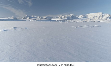 Infinitely, Infinitely polar snowy desert in Antarctica. South Pole frost surface. Scientific base. Snow covered mountains on horizon. Aerial view flight. Ice Landscape. Winter frozen ground drone fly - Powered by Shutterstock