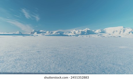 Infinitely, Infinitely polar snowy desert in Antarctica. South Pole frost surface. Scientific base. Snow covered mountains on horizon. Aerial view flight. Ice Landscape. Winter frozen ground drone fly - Powered by Shutterstock