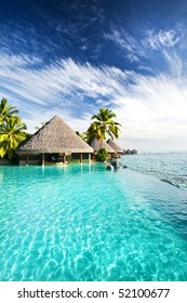 Infinity Pool With Artificial Beach And Tropical Ocean