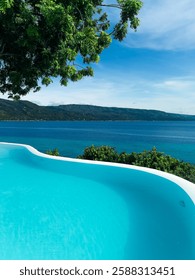 Infinity pool at Bluewater Sumilon Resort, Philippines, seamlessly blending with the turquoise ocean. A luxurious escape evoking peace, relaxation, and tropical vacation vibes. 