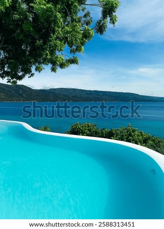 Infinity pool at Bluewater Sumilon Resort, Philippines, seamlessly blending with the turquoise ocean. A luxurious escape evoking peace, relaxation, and tropical vacation vibes. 