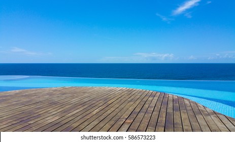 Infinity Pool With Ocean Views And Wood Deck