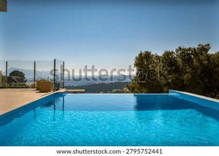 Infinity pool overlooking mountain landscape and forest views