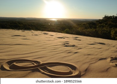 infinity sign painted in the sand on the beach in the desert of vietnam sand dunes of mui ne
