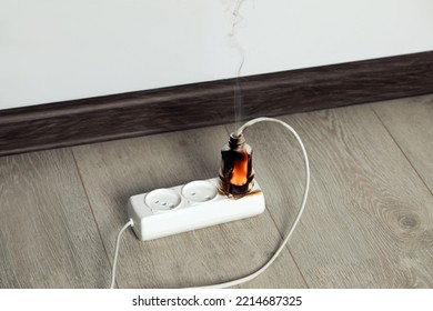 Inflamed Plug In Power Strip Indoors. Electrical Short Circuit