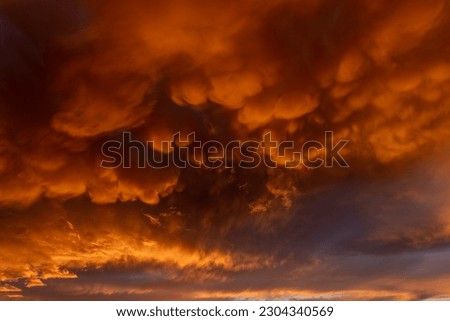 Inflamed sky with mammatus clouds at sunset. Saintes Maries de la Mer, Parc naturel regional de Camargue, Arles, Bouches du Rhone, Provence Alpes Cote d'Azur, France.