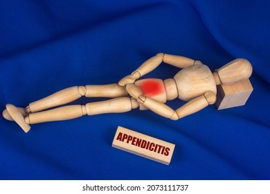Inflammation of the appendix. The wooden mannequin suffers from pain.