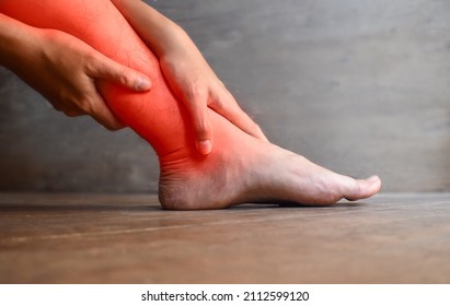 Inflammation of Asian young man leg. Concept of leg pain, tetany or calf muscle tenderness. - Shutterstock ID 2112599120