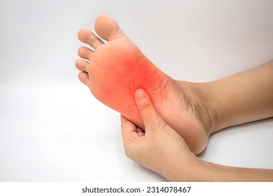 Inflammation at sole of Asian young woman. Concept of foot pain, plantar fasciitis, achilles tendonitis, etc.