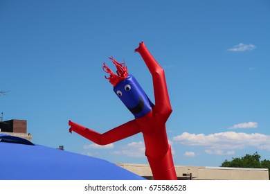 Inflatable Air Dancer Balloon Man On A Beautiful Summer Afternoon.