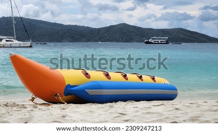 Inflatable banana boat for tourists to ride on the shore of the island